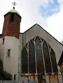 The rear of All Hallows showing the main church window and bell tower, which was used for tape storage.