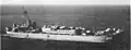 USS Blanco County (LST-344) underway off Guam in the 1960s with Army LCU-1517 land vehicles loaded on her main deck.