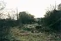 Blowers Green station forecourt in 2002. It has been fenced off since 2004 due to youths' anti-social behaviour, structural decay and periodical use by vagrants.