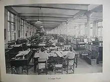 Female clerks attending to savings ledgers