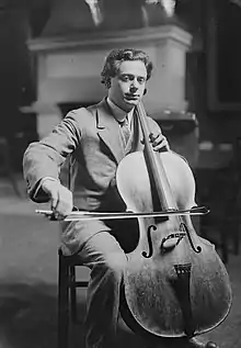 Boris Hambourg seated, playing a cello