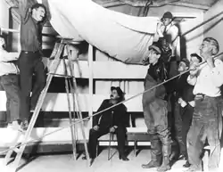 Setting up the stage for Bound East for Cardiff, Fall 1916. Photo shows O'Neill on the ladder, Cook to the far right.