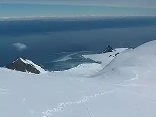 Catalunyan Saddle in the foreground, with Bransfield Strait in the foreground and the Antarctic Peninsula on the horizon