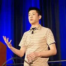 Brendon Chung delivering a speech from behind a podium.