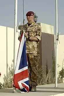 A British soldier of the Royal Artillery, with No. 5: Desert Combat Dress shirt and trousers.