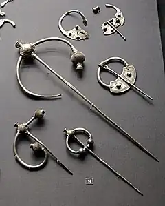 display of silver brooches, some broken up