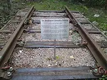 Short length of railway track and a metal sign