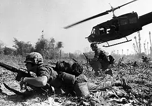 Major Bruce P. Crandall's UH-1D helicopter climbs after discharging infantrymen on a search and destroy mission in Ia Drang Valley in November 1965. .