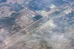 Royal Brunei Air Force Base, Rimba (top left) shares its 3,685 metres (12,090 ft) runway with the Brunei International Airport (bottom right), 2016.