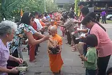 Image 44Buddhist novices receiving joss sticks. (from Culture of Thailand)