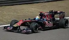 Sebastien Buemi driving a Formula One car at a practice session in China in 2010