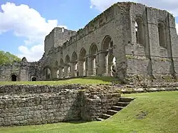 A photograph showing a well preserved section of arcade made up of early Gothic arches.