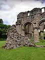 The south west corner of the church, showing all that remains of the abbey's aisle walls and a section of foundation.