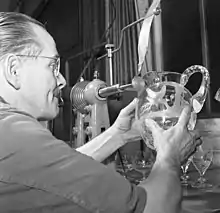 man with decorated glassware