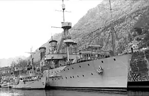 a black and white photograph of a ship at dock