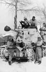 Snow-camouflaged German Marder III jagdpanzer and white-overalled crew and infantry in Russia, 1943