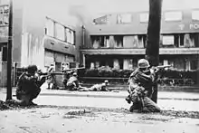 Soldiers hide along streets during an urban battle