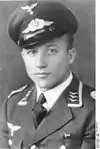 A man wearing a peaked cap and military uniform.