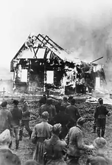 Image 33German soldiers and locals watch a Lithuanian synagogue burn in 1941. (from History of Lithuania)