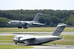 A C-17 Globemaster III from the 305th Air Mobility Wing at McGuire Air Force Base, New Jersey, performs touch and go landings while another C-17 prepares for take-off on Wednesday.