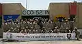 C-52d IN poses with a Thank You banner from Lacey, Washington. August 2004