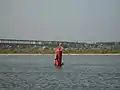 Children playing on a buoy in the Volga