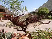 A cheetah sculpture in front of two buildings at the Cheetah Conservation Fund's Field and Research Centre in Otjiwarongo, Namibia