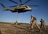 Marines supporting Weapons and Tactics Instructors (WTI) Course 1-14, participate in a CH-53E Super Stallion sling loading exercise at Landing Zone Bull (2013).