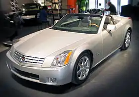 Cadillac XLR c. 2007, with fully retracted aluminum (i.e., lightweight) hardtop concealed by self-storing tonneau cover, the hardtop manufactured by a supplier joint venture of Mercedes-Benz and Porsche