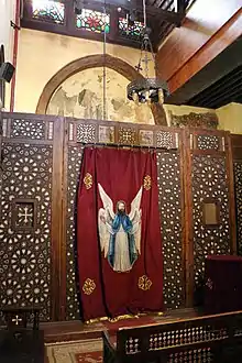 Image 10Side chapel in the Hanging Church in Old Cairo, including frescoes (partly visible behind the screen here) dating from the late 12th or 13th century, before the church's later renovation (from Fatimid Caliphate)