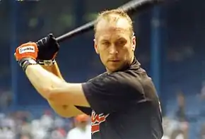 A man in a black baseball jersey and cap