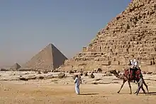 Image 41Tourists riding an Arabian camel in front of Pyramid of Khafre. The Giza Necropolis is one of Egypt's main tourist attractions. (from Egypt)