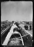 Canal, by old aqueduct near Pisa. These boats bring some of the material for building the ARC concrete village.