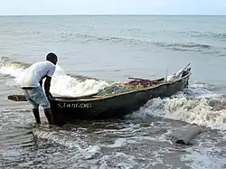 A fisherman and his canoe at Praia Melão