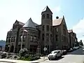 Carnegie Free Library of Braddock in Braddock, Pennsylvania, built in 1888 and designed by William Halsey Wood. The 1893 addition by Longfellow, Alden & Harlow is to the right of and including the octagonal tower.