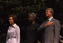 The Carters and Julius Nyerere standing next to each other outside.