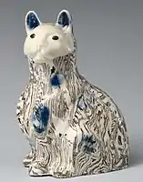 Cat, c. 1745, with agateware effects, and underglaze blue highlights