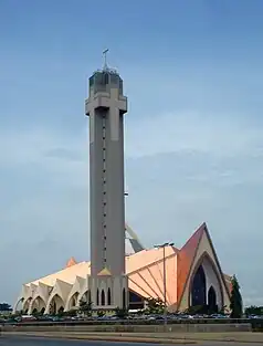 spire and rooftop of very modern design against blue sky