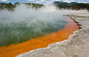 The orange colour originates from deposits of arsenic and antimony sulfides