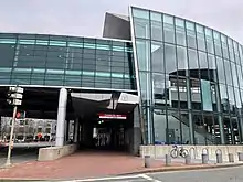 A curved glass entrances building for an elevated railway station