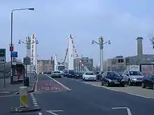 Road atop a suspension bridge, with two lanes of car traffic in each direction.