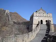 A stone wall going uphill with towers spaced along it (from Human history)