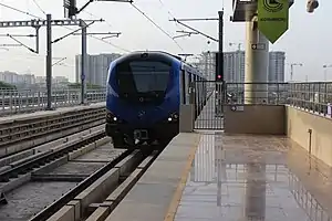 A Metro train arriving at Koyambedu station in 2015