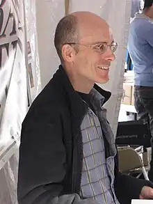 Photo of a bald middle-aged man in glasses