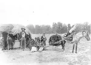 Image 38Stump Horn and family (Northern Cheyenne); showing home and horse-drawn travois. (from History of Montana)