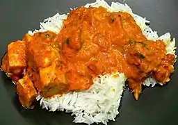 Image 8Chicken tikka masala, served atop rice. An Anglo-Indian meal, it is among the UK's most popular dishes. (from Culture of the United Kingdom)