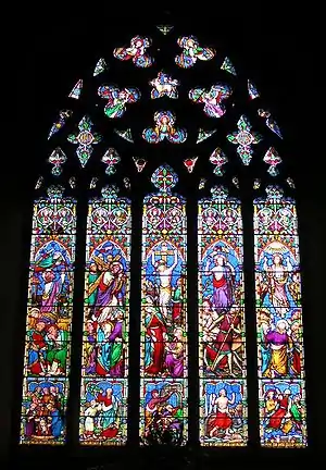 William Wailes. This window has the bright pastel colour, wealth of inventive ornament, and stereotypical gestures of windows by this firm. St Mary's, Chilham