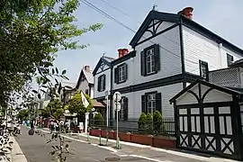 A row of non-Japanese looking wooden houses along a street.