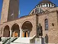 The entrance of the church with a statue of Constantine XI Palaiologos