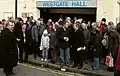 Users of Westgate Hall gather to object to the Council closure of the hall, 2010. Cllr Alex Perkins (left); Cllr James Flanagan (centre, holding papers)